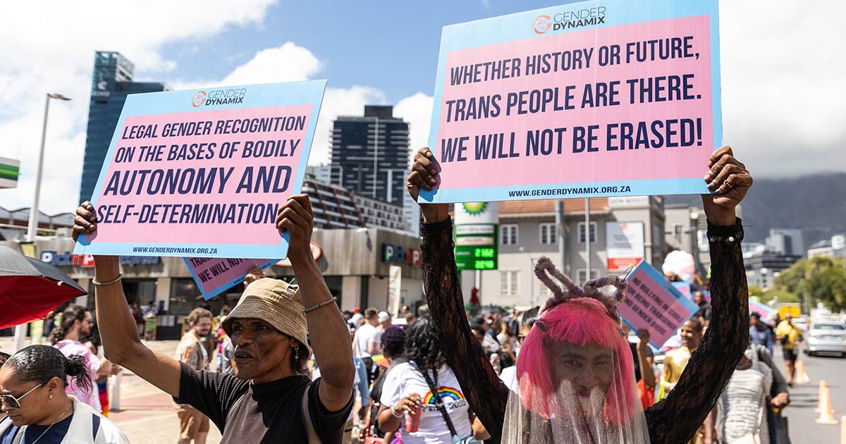 A photo of members of trans and gender rights organisation Gender Dynamix marching in white, blue and pink - the colours of the trans pride flag.